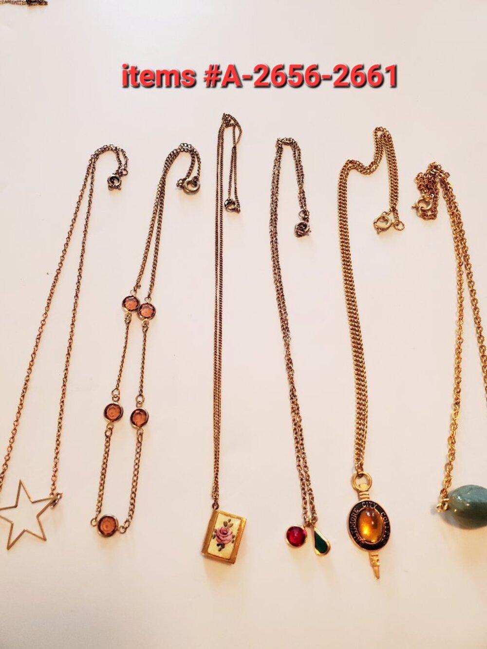 6 Gold Chain Necklaces with small pendants, items# A-2656-2661, wt. 23 grams.